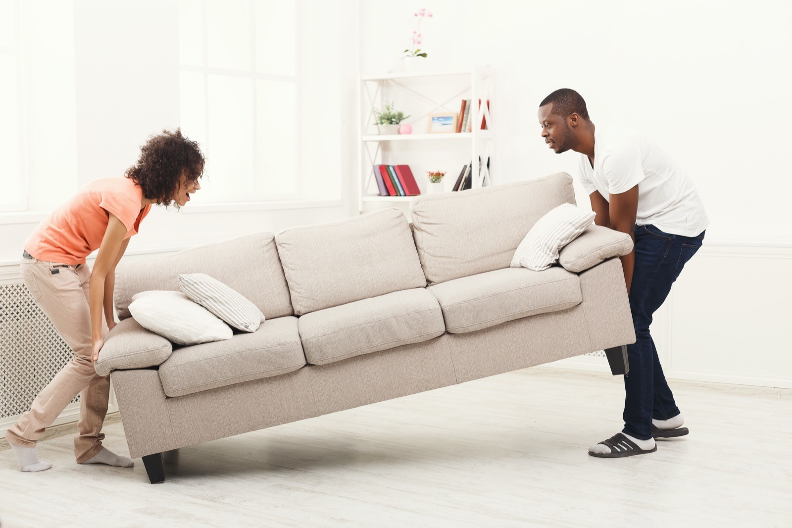 Couple moving couch | Flooring by Wilson's Carpet Plus