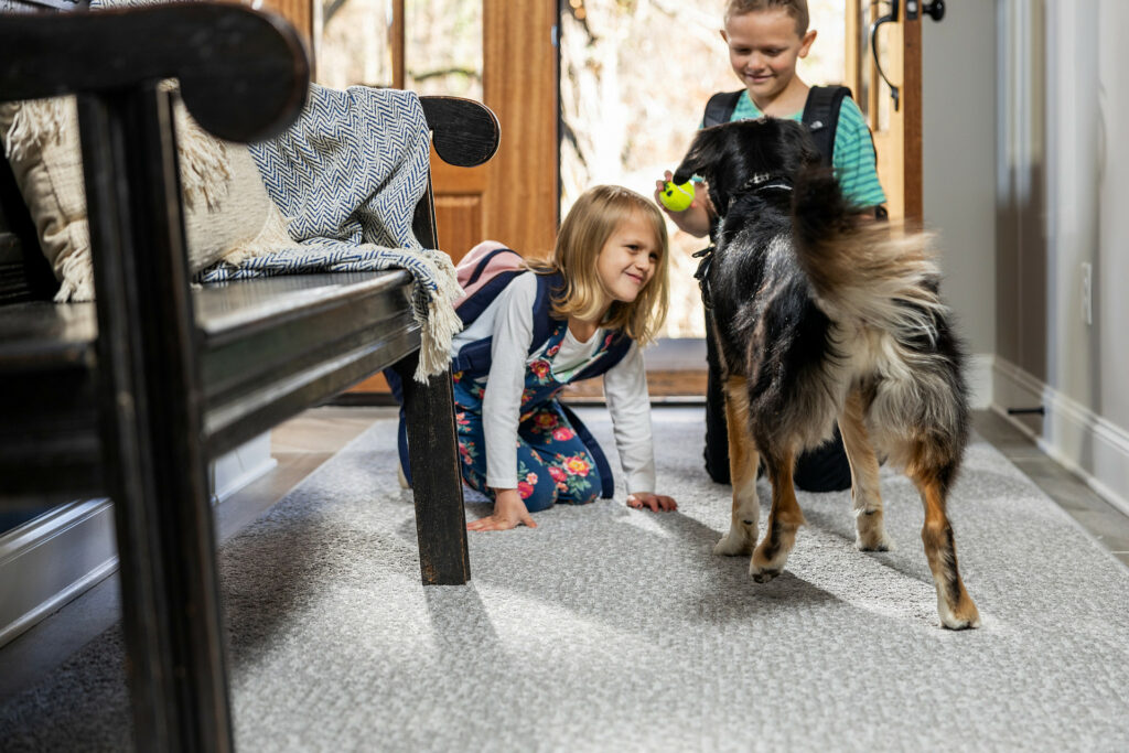 Kids playing with dog on carpet floors | Flooring by Wilson's Carpet Plus