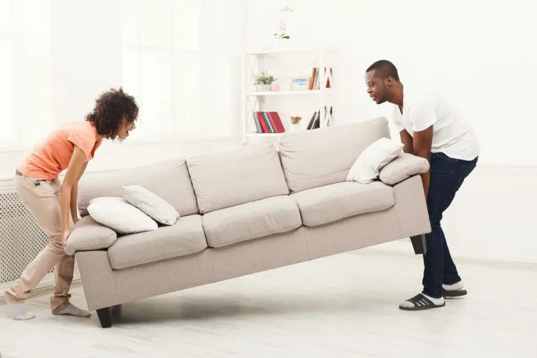 Couple moving sofa