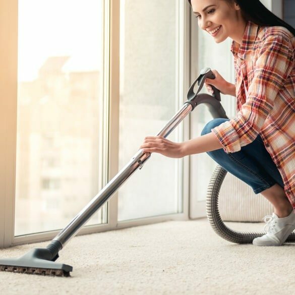 woman vacuuming carpet | Flooring by Wilson's Carpet Plus